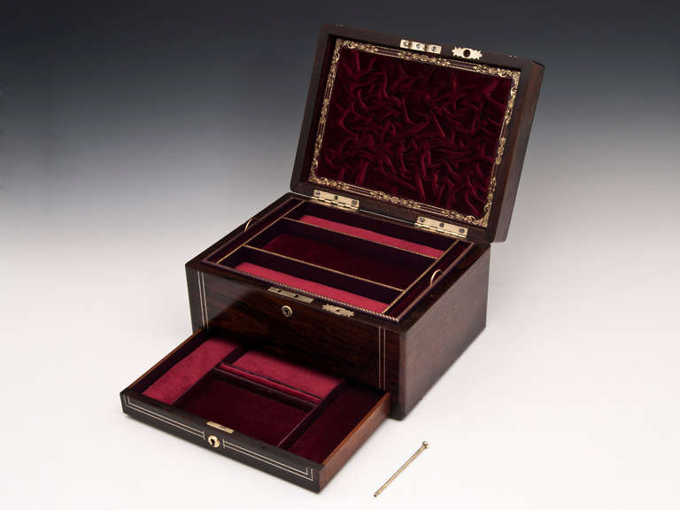 jewellery box double strung with pewter stringing and has beautiful intricate floral inlaid Mother of Pearl on the top.

The inside of the lid features a burgundy ruched velvet letter compartment with a finely detailed gold tooled border.

The
