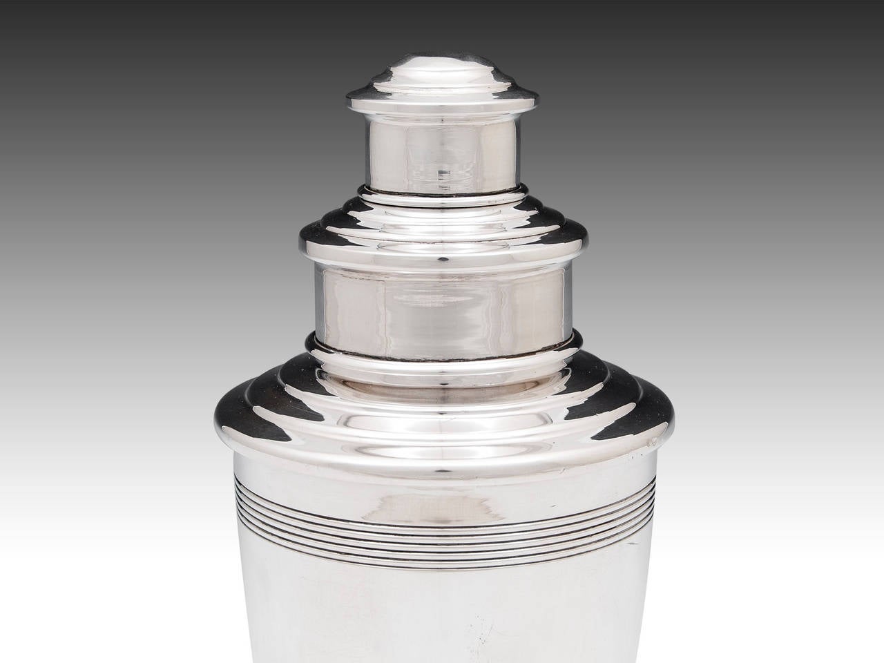 Art Deco Silver plated cocktail shaker with interesting step design design typical of works by Keith Murray, has removable top and strainer. Slight dent to top of shaker.

Shipping Cost: 
United Kingdom £25 
Europe £45 
International £65