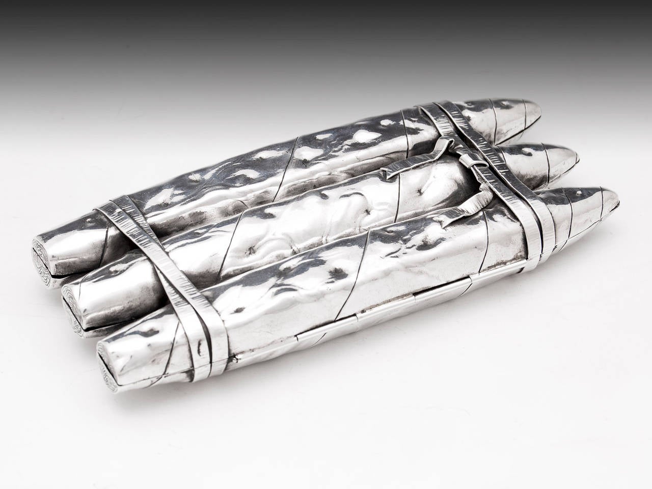 Sterling Silver Cigar case by renowned American silversmith, Gorham Silver. 

Beautifully detailed sterling silver cigar case in the form of three ribbon tied rolled cigars. 