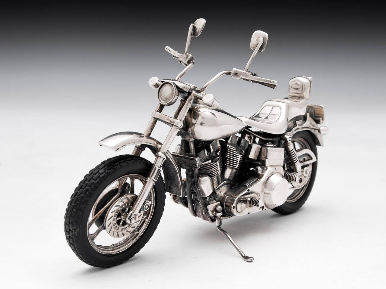 Harley Davidson FXE motorcycle of the 1970s made of sterling silver in Arezzo, Italy.

The entire very rare Harley Davidson motorbike is made of sterling silver with exquisite attention to detail, rubber wheels and features moving handlebars,