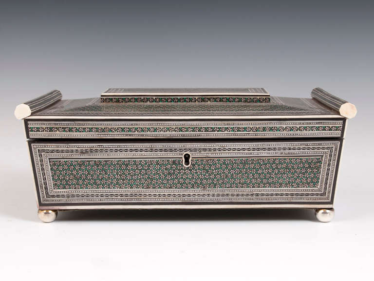 Anglo Indian Work Box

Fine sarcophagus shaped Anglo Indian Work Box veneered in repeating patterns of Sadeli hexagons & stars made up of Green stained Bone, natural Bone, Paktong, Ebony and bone all on a sandalwood carcass.

The Sadeli work box