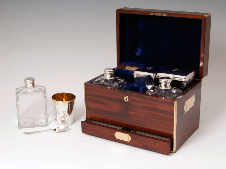 Officer's Campaign Silver Travelling Drinks Box

Brass-bound Mahogany box with campaign flush-fitting carrying handles, with a small handle for a cigar drawer to the front. A lion's crest is engraved on the brass plate to the top of the box which