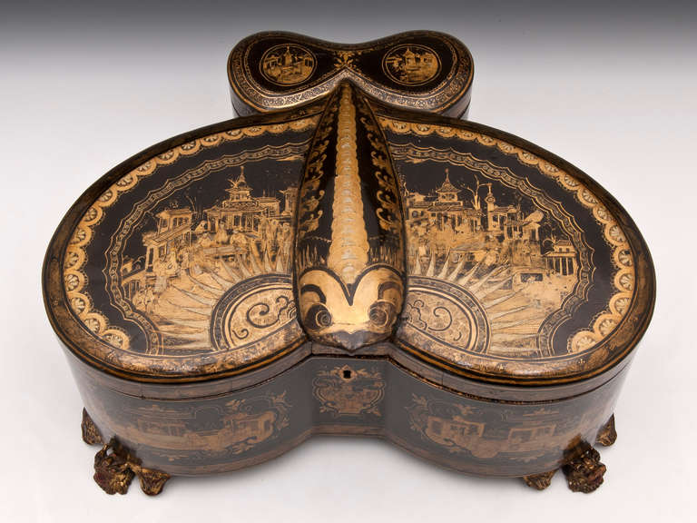 Fabulous rare shaped Chinese tea caddy, decorated with oriental scenes, temples and pagodas. Stands on three stunning winged dragon feet. 

The interior contains three engraved paktong canisters, two of large proportions, the smaller possibly for