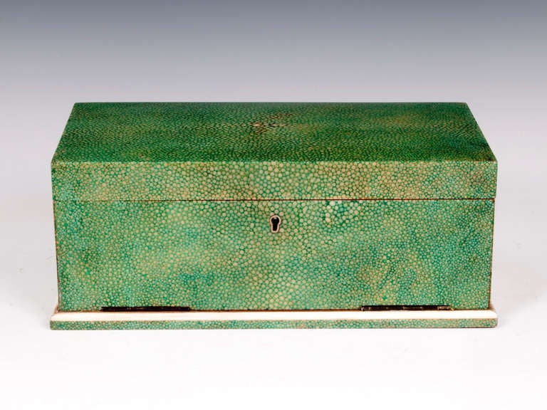 Art Deco Shagreen Card Box with a hinged, fold down front, once belonged to Lady Hambledon of the famous shop chain WHSmiths. 

This Shagreen box is a vibrant green colour with a smooth polished finish and sits on Ivory edged base, its interior is