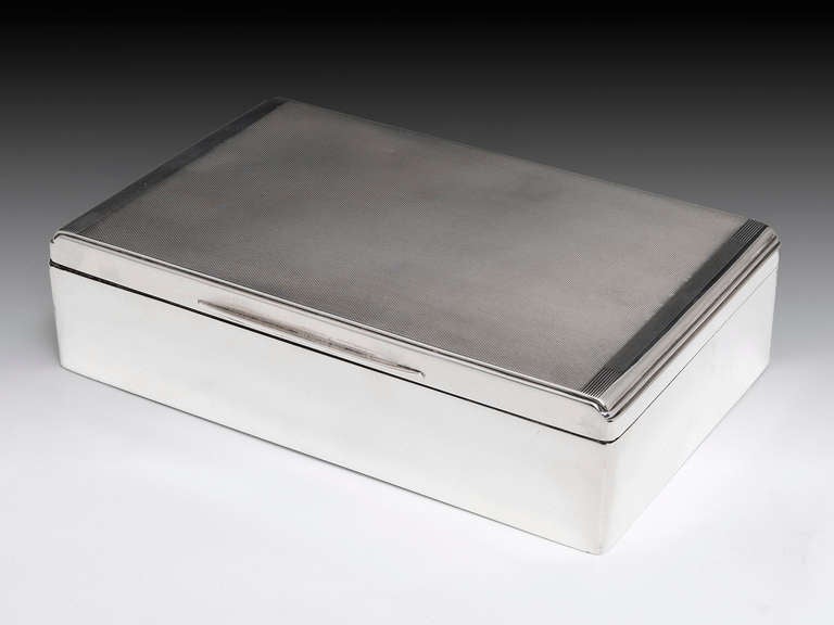 Large sterling silver cigar box with engine turned top with detailed stepped edge, the front has a finger plate to allow ease of opening, the sides are plain with the left hand side being hallmarked by Birmingham Silversmiths William Neal & Son Ltd,