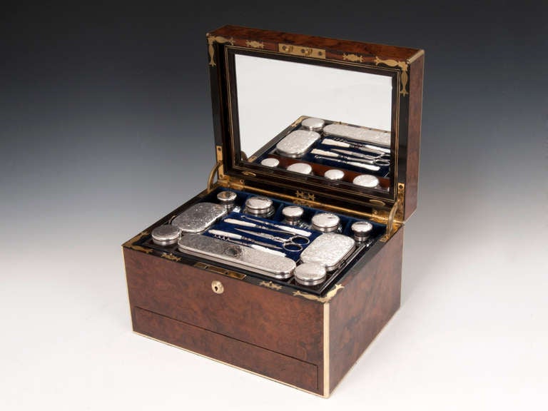 Burr Walnut Sterling Silver Vanity Box with brass edging and escutcheons, hallmarked Birmingham 1871. 

The lid of the Antique Dressing Box is lined with a blue ruched velvet, this springs forward to reveal a reversible mirror & letter envelope