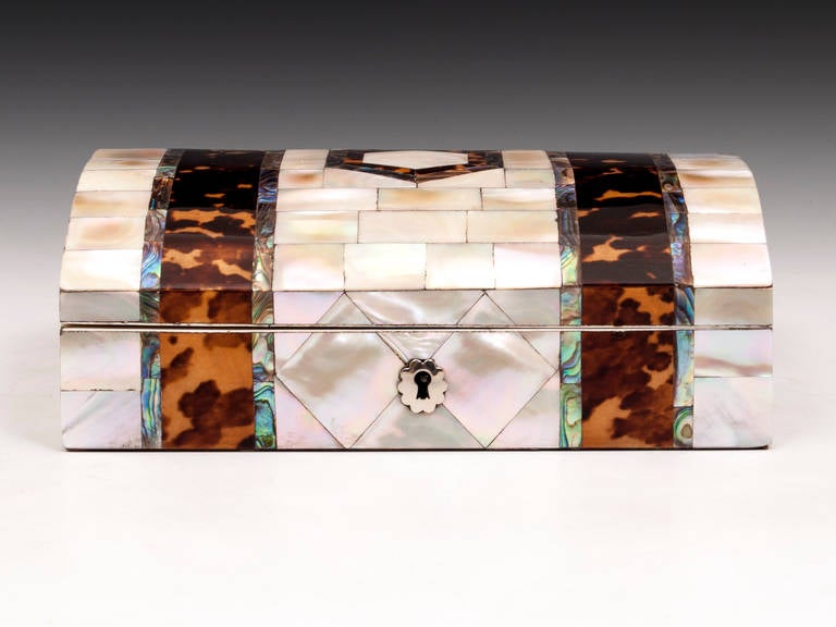 Mother of Pearl jewelry box with abalone and tortoiseshell bands and silver escutcheon. The interior features diamond padded red silk lining with gold rope edging. This jewelry box comes with a fully working lock and tasseled key.
Shipping Cost: