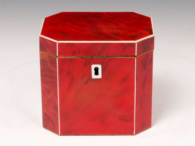 Extremely rare octagonal Red Tortoiseshell Tea caddy with Bone edging, silver escutcheon. 

The interior of this rare tea caddy has a bone handled lid and has traces of its original tin lining. 

This wonderful Red Tortoiseshell Tea Caddy comes with