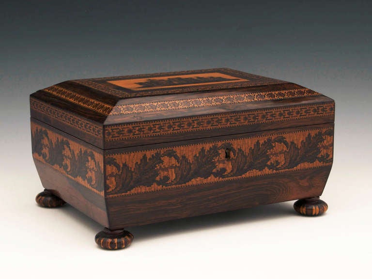 Delightful Tunbridge Ware Sewing box veneered in rosewood with a view of Eridge Castle, it has a border of geometric tessellated inlays around the top and front with trailing leaves surrounding the front, back and sides of the box. The Tunbridge