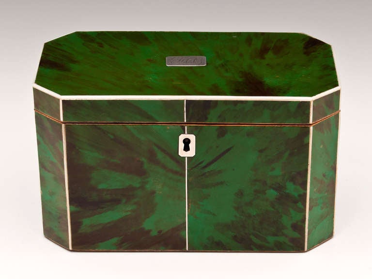 Rare octagonal Green Tortoiseshell Tea caddy with Ivory edging, silver stringing and silver engraved initial plate and escutcheon. 

The interior of this rare tea caddy has two green tortoiseshell lids with bone handles and a velvet lined lid.