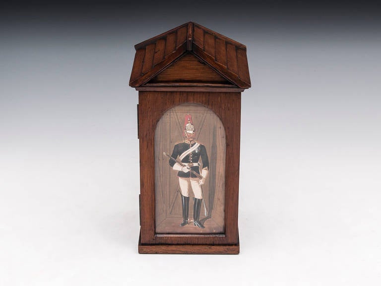Rare miniature sentry cigar or cigarette box made from English oak with glass front and original water colour of a Royal Horse Guard known as 