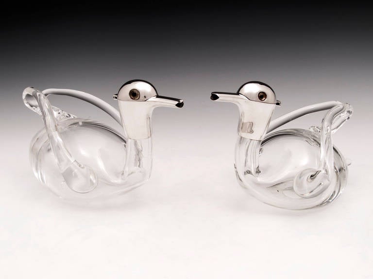 Matched Pair of sterling silver Duck shaped decanters by famous Birmingham silversmiths, Hukin & Heath. 
The heads are sterling silver all hallmarked and dated, they're hinged to allow you to pour your drink, the body is made of glass and has a