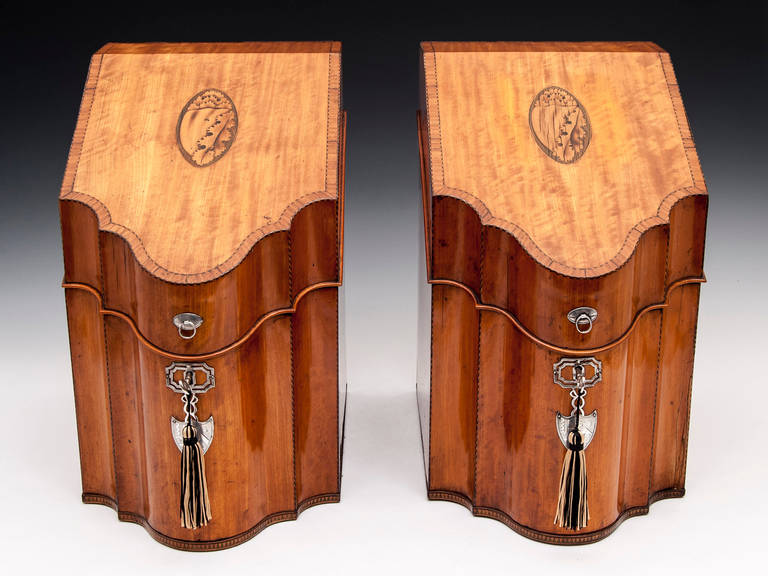 Exquisite pair of satinwood knife boxes with inlaid conch shells on the top, chequered string edging and tulipwood cross banding which continues inside on the solid satinwood cutlery decks. 
The fronts have silver escutcheons and finger plates,