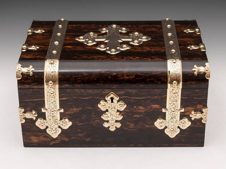 Coromandel and satinwood games compendium.

The antique games compendium has beautiful elaborate engraved brass bands run from front to back, with further decorative brass edging and escutcheon, it also has an engraved brass plaque which reads