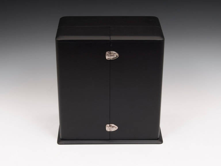 Limited edition Alfred Dunhill clock with original leather case.

Featuring a round green tinted glass dial with stylish chrome numerals, standing on a stone plinth.

The rear of the mechanism reads.
