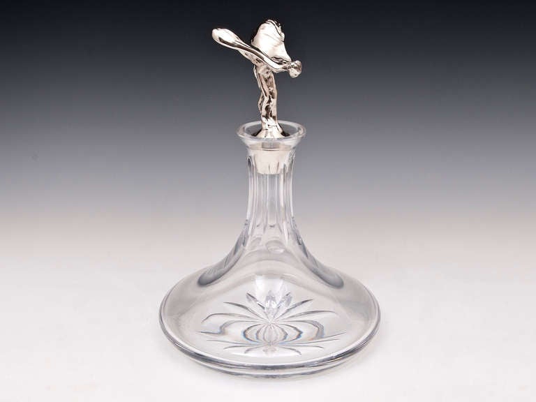 Rolls Royce Decanter featuring sterling silver Spirit of Ecstacy stopper. 

The sterling silver stopper was made by Guernsey silversmith Bruce Russell in 1988 The silver marks on the bottom of the stopper are: Guernsey heraldic crest, 925 silver,