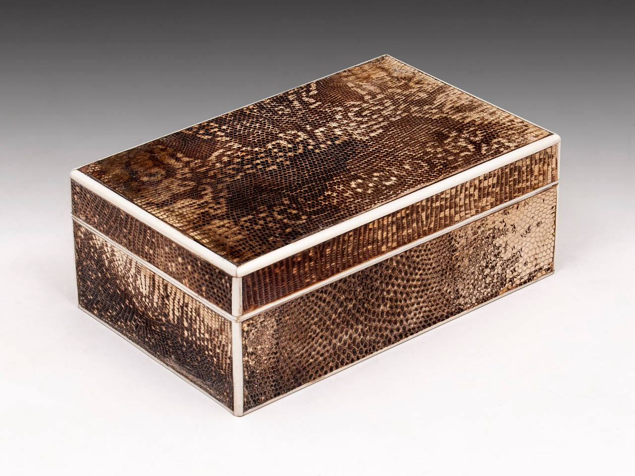 Art Deco Snakeskin cigarette box with ivory edging & lips. 

The interior is lined with satin cedar and features a piano hinge. 

Important information below. 

If you are purchasing Tortoiseshell or Ivory pieces and are outside the E.U. you
