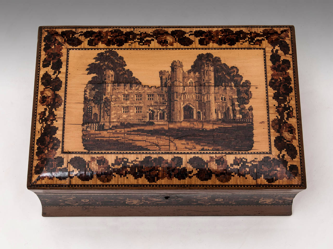 Tunbridge Ware Jewellery Box with a view of Battle Abbey veneered in water stained maple surrounded by a floral tunbridge borders. 

The interior features its original green velvet lined tray with various compartments including two for rings,