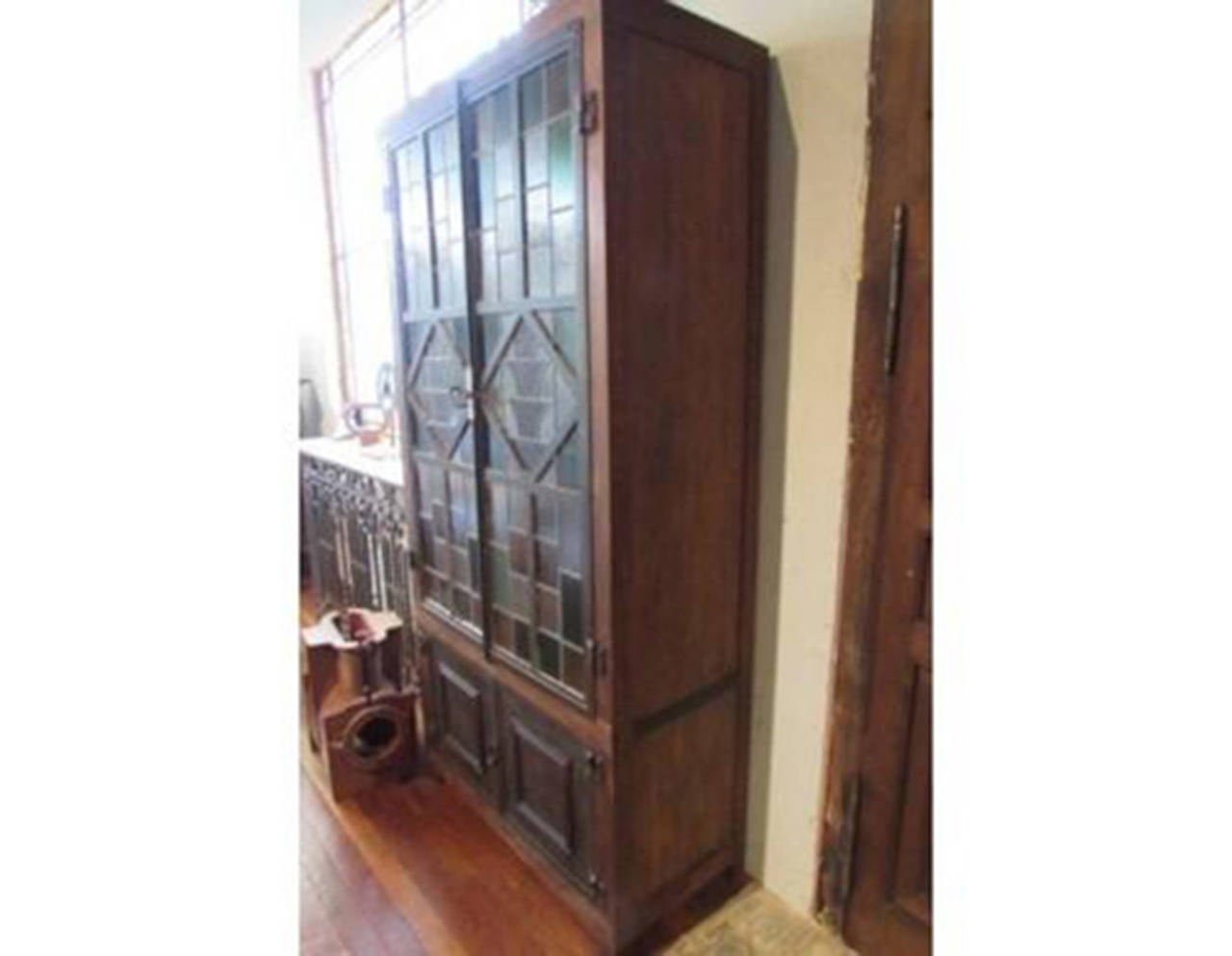 Antique retro style wooden wardrobe with stained glass doors at the top. 
Three shelves.
Two wrought iron door at the bottom.