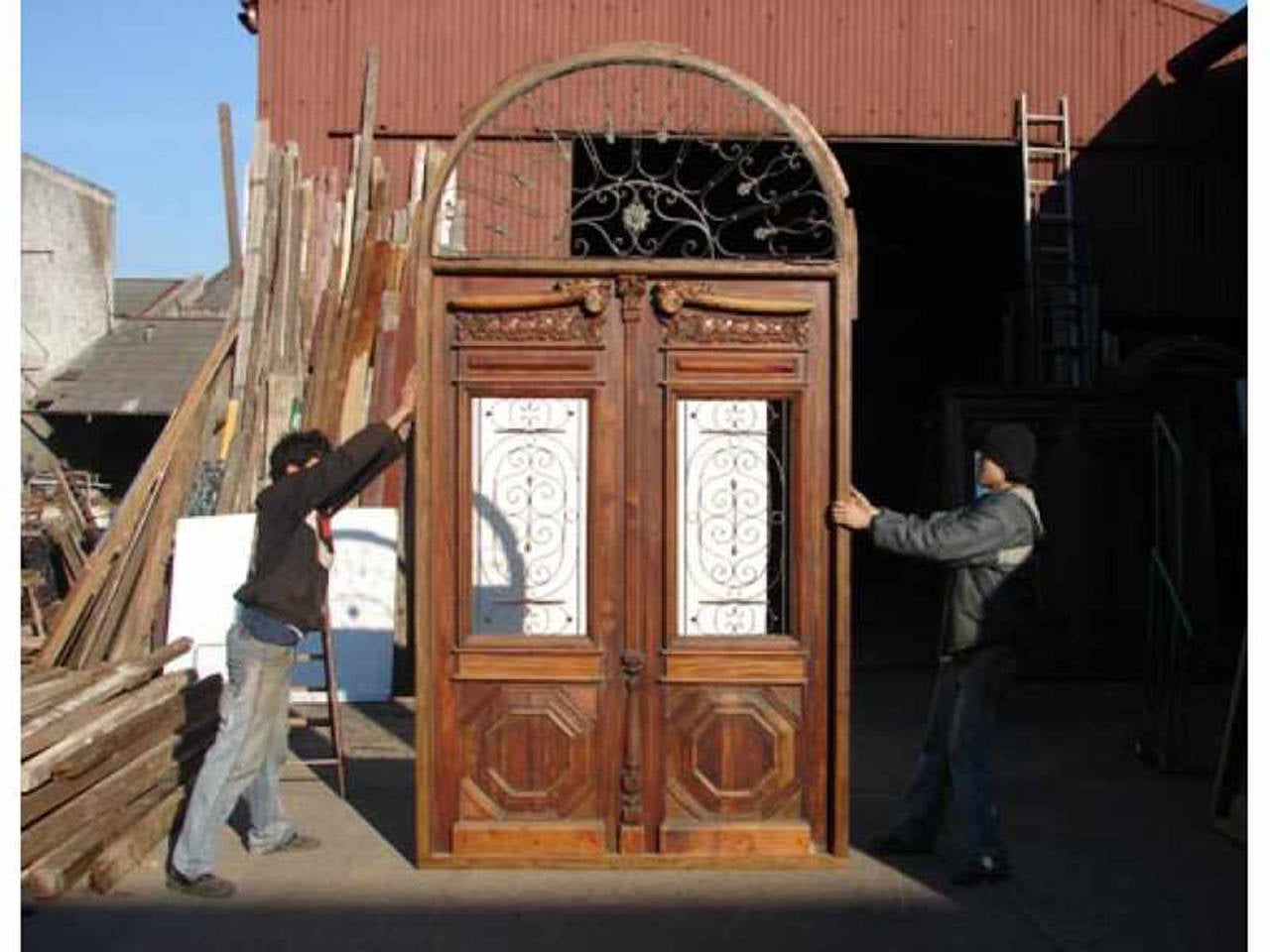 Amazing arched top double front door. It has amazing high relief details made by hand at the top. Also has stunning wrought iron inserts at the transom and door with hexagonal panels at the bottom.

DETAILS:

Overall Dimension:67 3/4