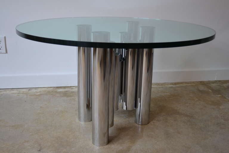 Awesome Mid-Century Modern period piece. Chromed tubular base with a round 36 inch diameter glass top. The glass is a substantial .75 inches thick.