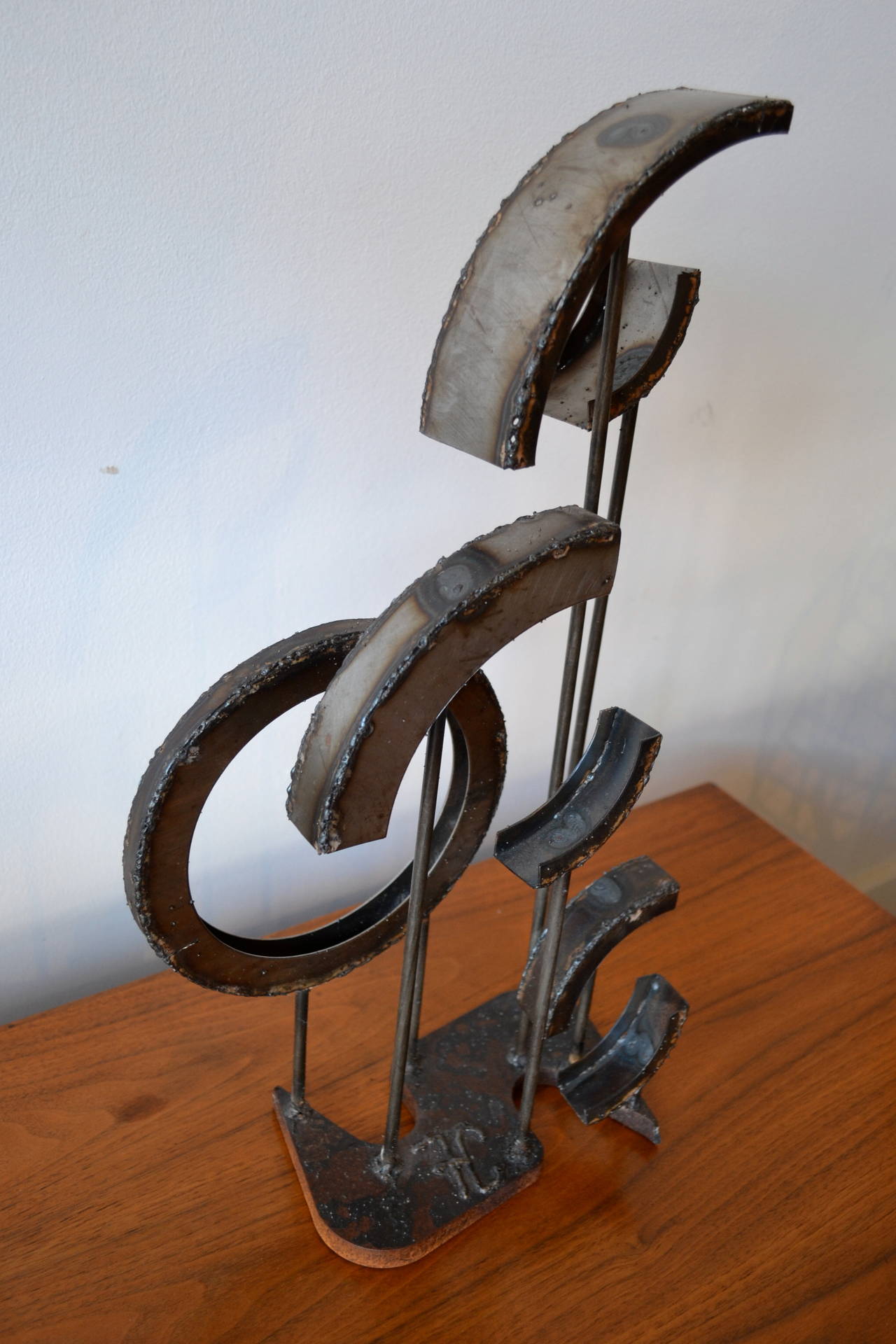 Welded metal circle and semicircle sculpture by American artist Frank Cota, signed.