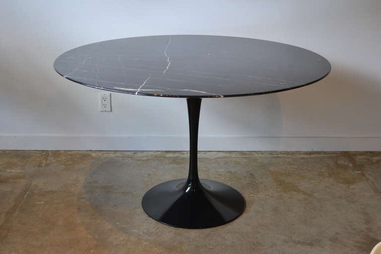 black on black knoll round dining table designed by eero saarinen.  italian production, aluminum base, beautiful black carrera marble top.