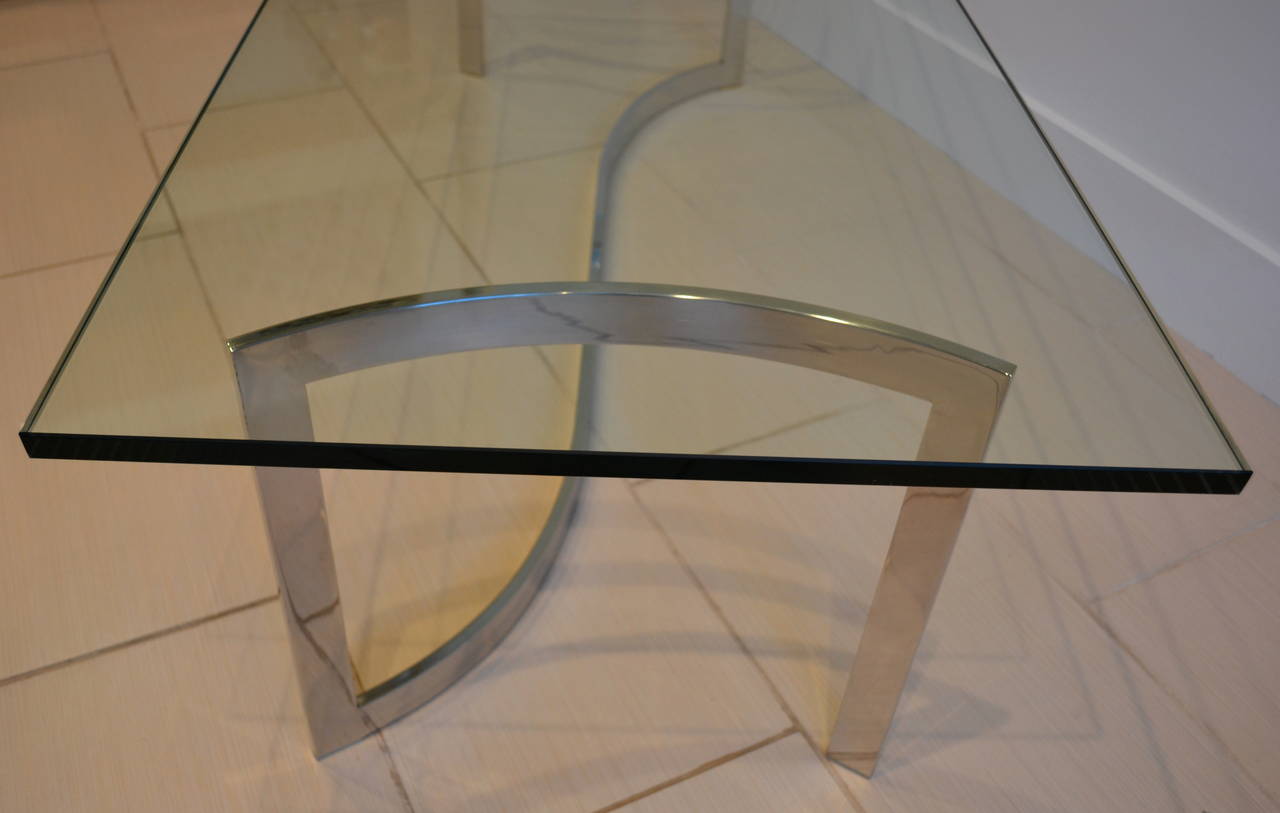 very sleek curved chrome base coffee table with thick glass top, italy