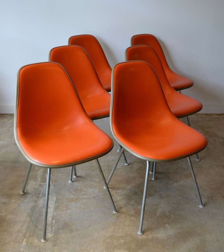 6 original herman miller dining chairs covered in orange vinyl.  great condition, minor wear and faint stains on two of the chairs.