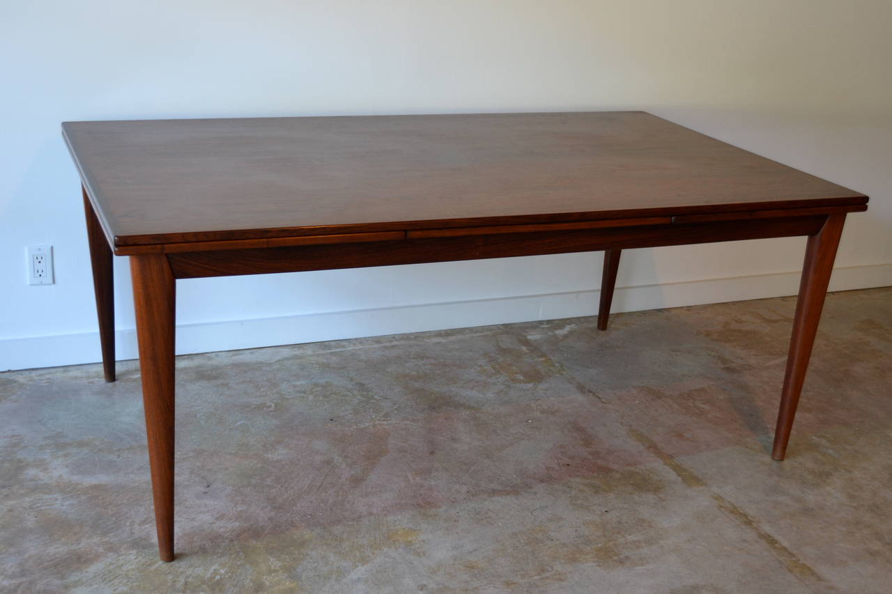 beautiful rosewood dining table designed by niels moller for jl moller, denmark.  leafs expand table to massive 116