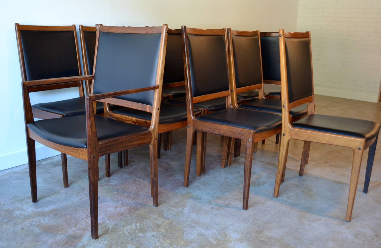 Amazing set of 12 rosewood and black leather dining chairs by Niels Moller for JL Moller, Denmark. two captains chairs and ten-arm less, in great condition.