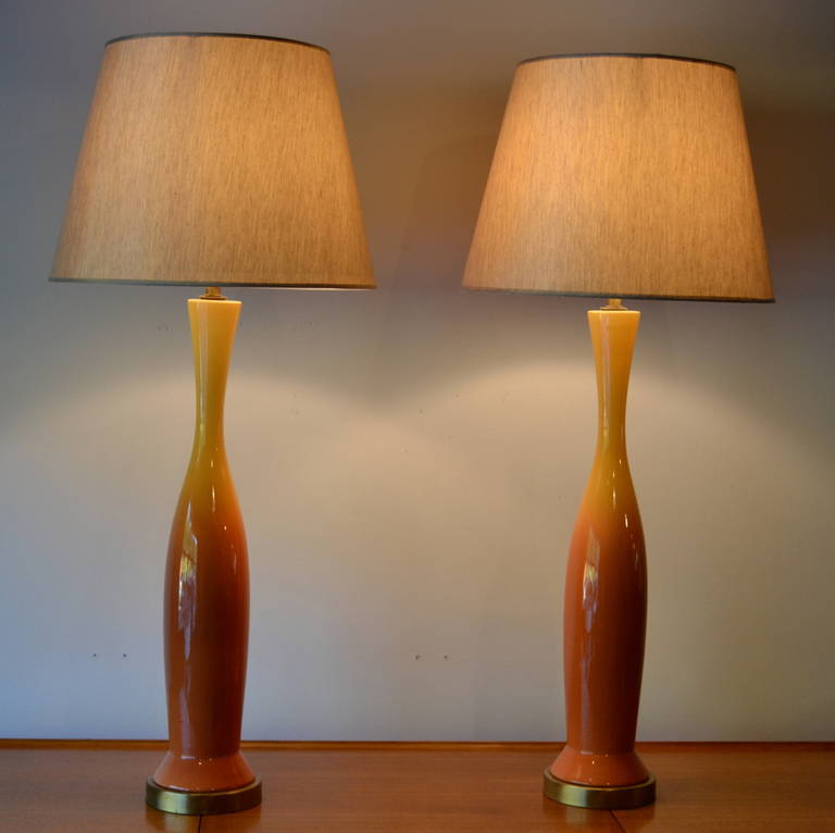 Exceptional pair of ceramic glazed table lamps. Awesome height measures at 30 inches.  Yellow to orange ombré. Professionally rewired. Shades not included.