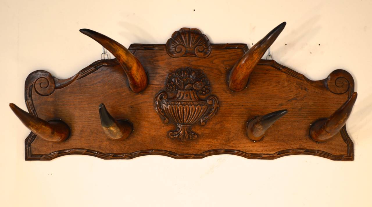 19th-C. French hanging wall hat rack with lovely hand carved decoration and cow horn hooks.