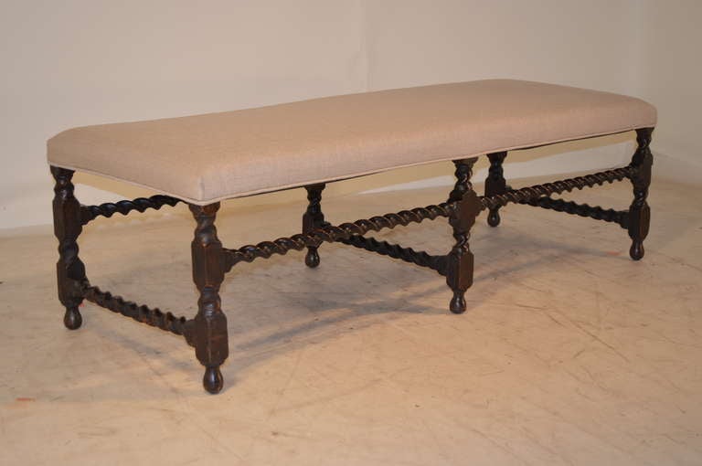 Period Charles II bench with barley-twist legs and stretchers. Newly upholstered in linen. The wear and patina on this piece is fantastic - an early treasure.