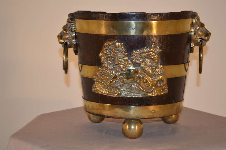Early 19th-C. English oak strapped planter with hand made brass straps and decoration. The front is decorated with a fantastic lion and unicorn, which is a typical combination on English coat of arms. The handles on the sides are wonderfully