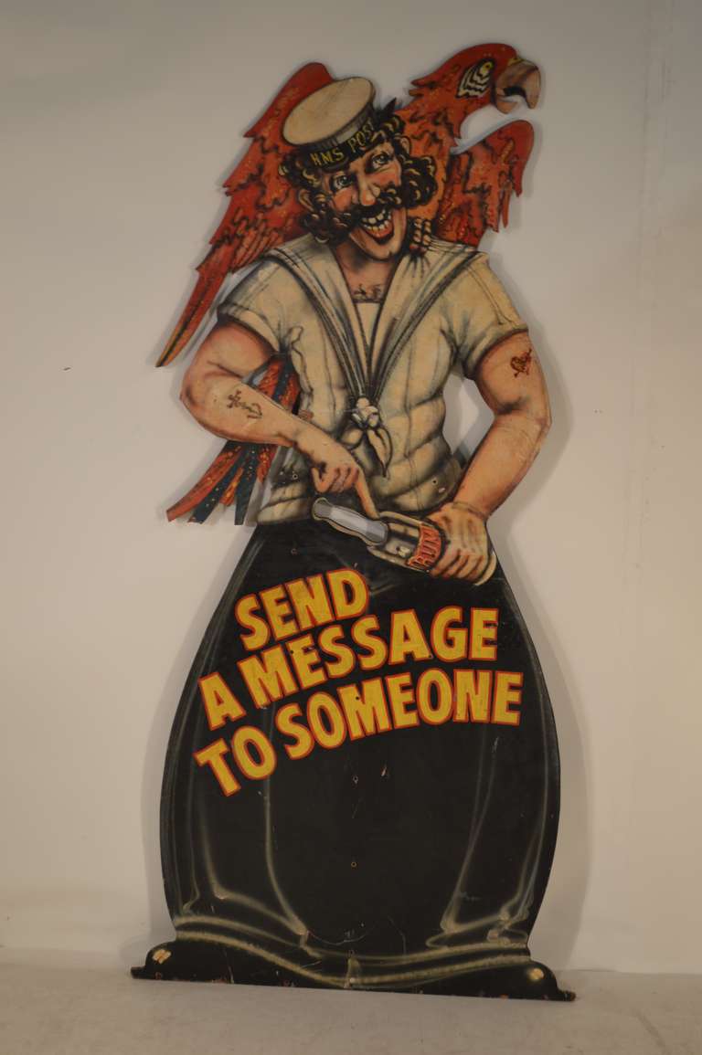 c. 1930-1950 English sign depicting a sailor with a parrot on his shoulders.  There is a slot to mail a letter in the neck of his rum bottle.  Utterly charming.  Stand is missing on the back.