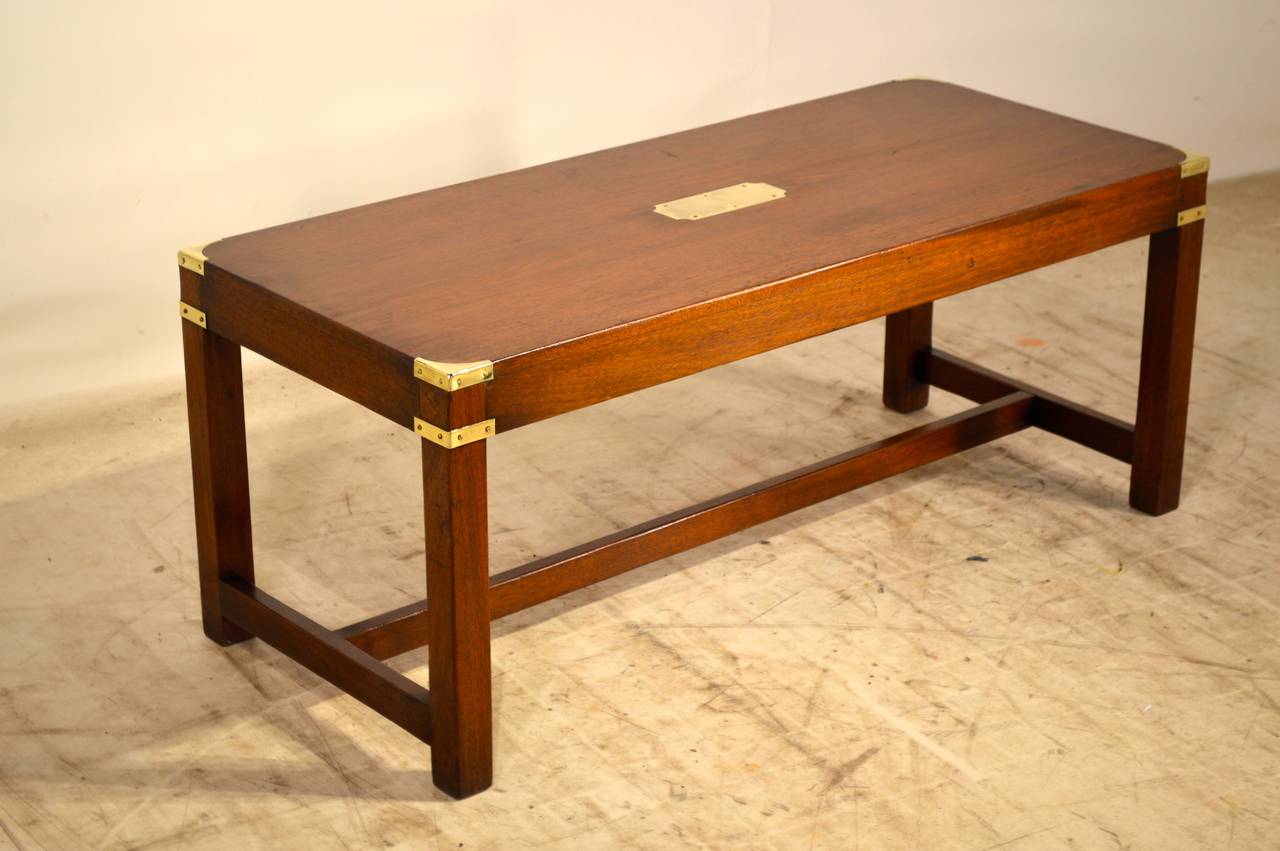 English Campaign style coffee table made from mahogany and banded in brass, circa 1940.