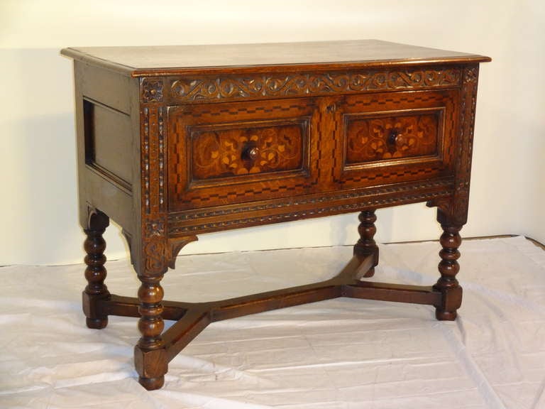 19th-C. Welsh Inlaid server using oak, satinwood and mahogany.  The top has a beveled edge over a hand carved case.  The sides are wonderfully paneled as well.  The drawer is artfully inlaid with patterns of geometric border, fading into a molded