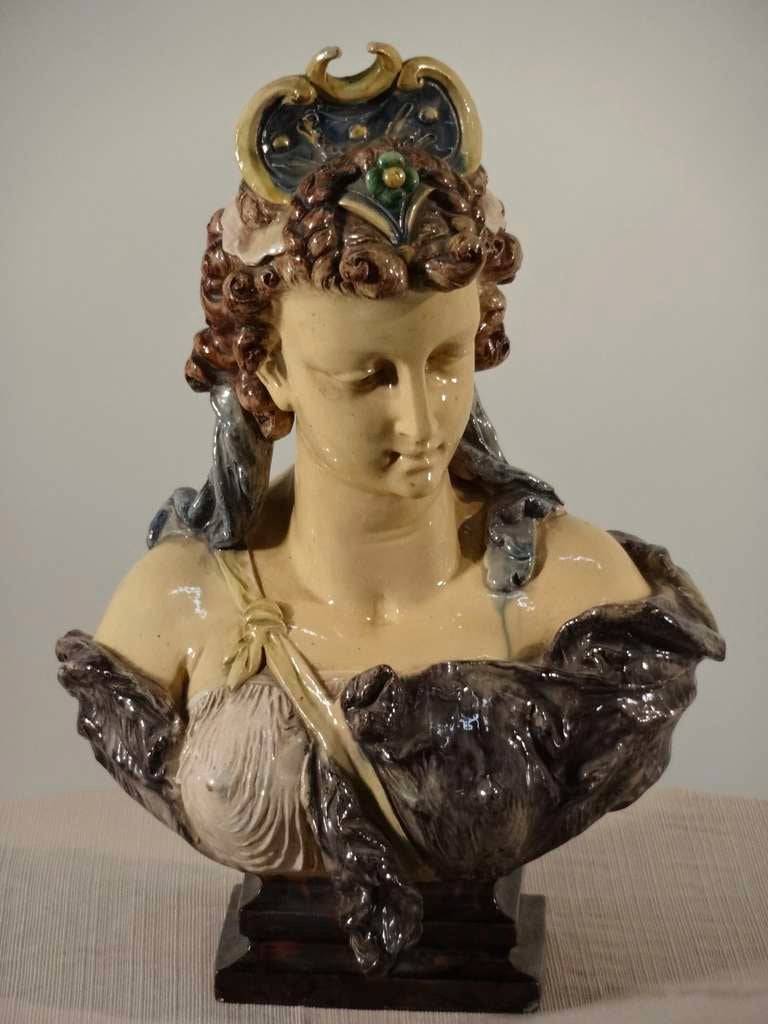 19th century French Majolica bust in the figure of a woman. Lovely detail in sculpture, glaze is vibrant, some glaze drips. Great molding detail. Slight nibbles around base of statue and top of hat has had restoration.