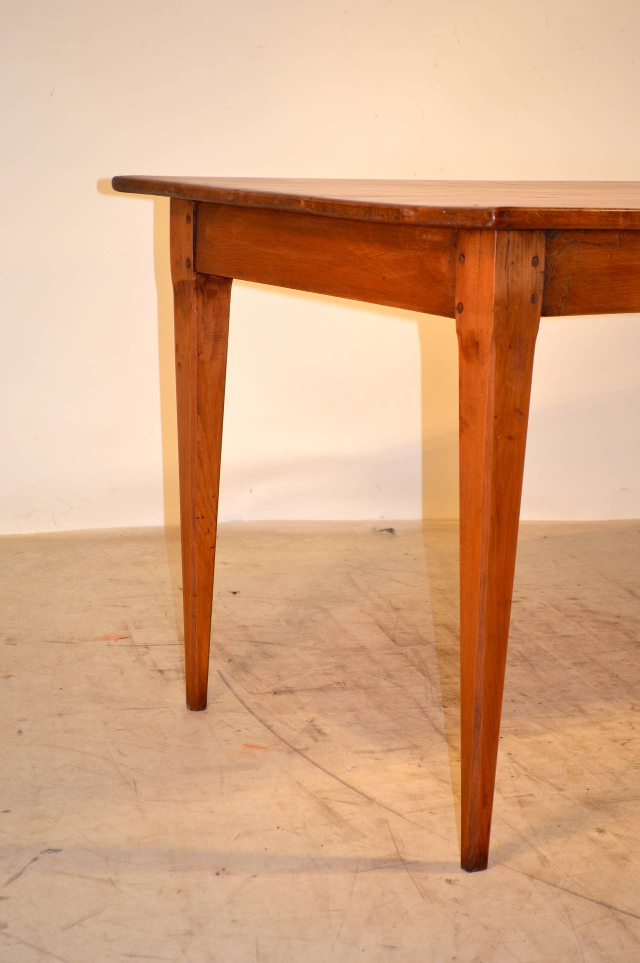 19th-C. French Cherry farm table with a plank top, a simple apron containing one drawer, following down to tapered legs.  Gorgeous color.