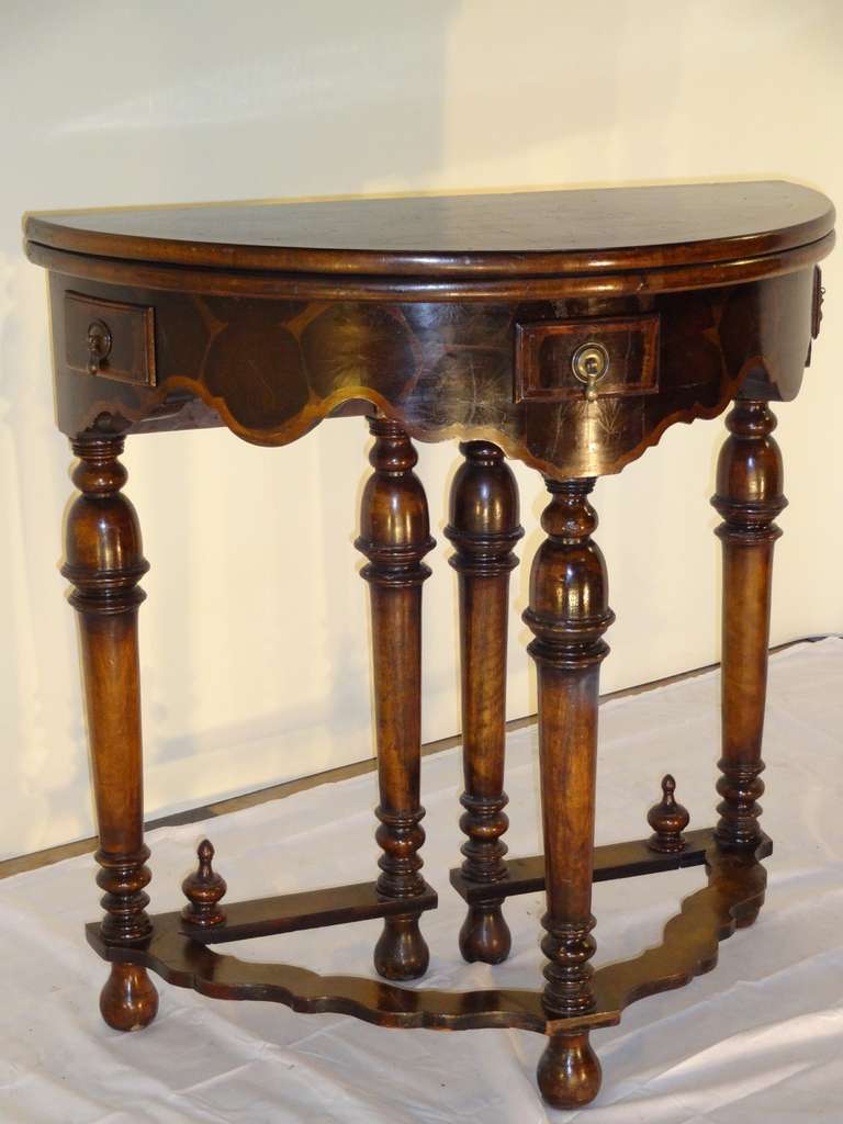 18th-C. English game table made from Walnut and Oyster Walnut. The table is solid Walnut with fabulous inlaid top and apron in Oyster Walnut for a wonderful contrast. Wonderfully turned legs with bell shapes and turnings.  On bun feet.