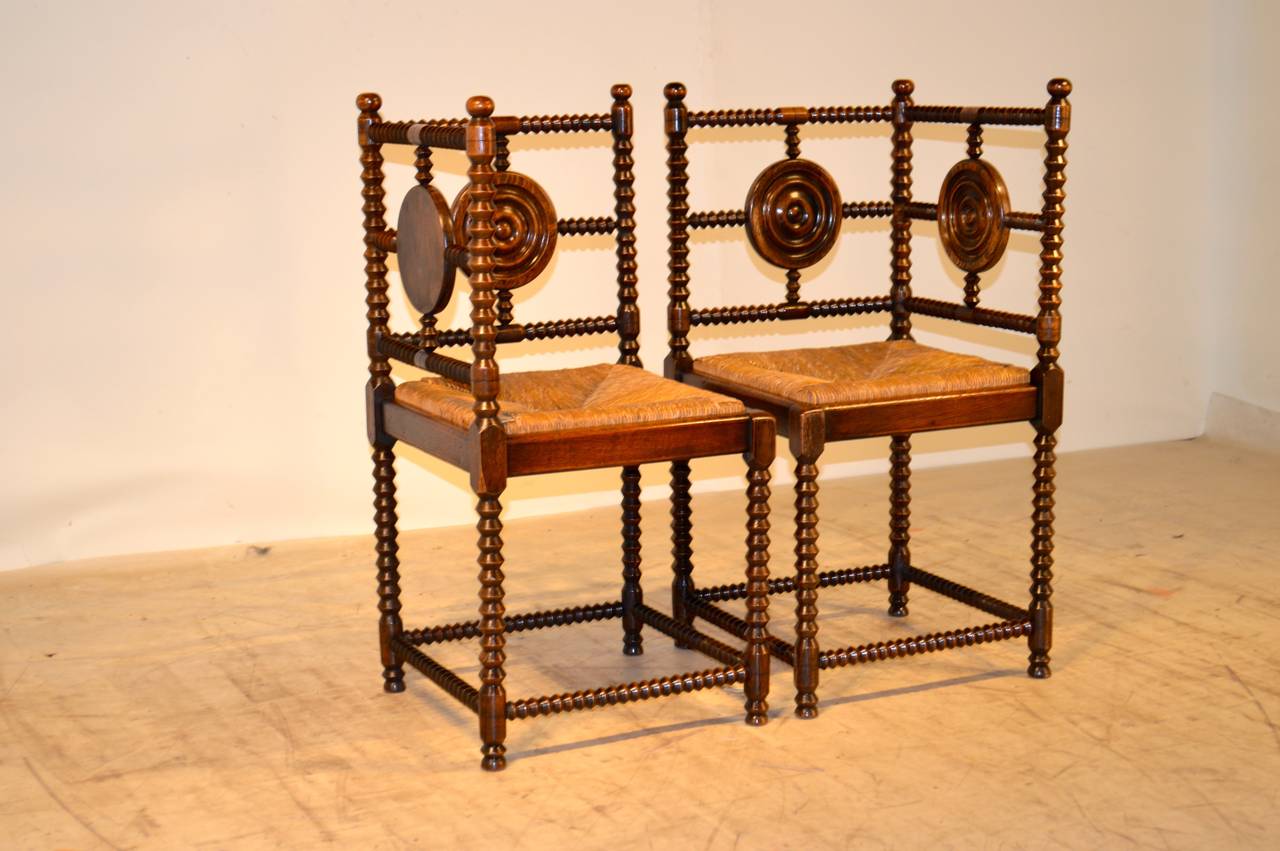 19th-C. Pair of French corner chairs with lovely spool turned frames with central turned medallions in the backs.The seat height measures 16.5.
