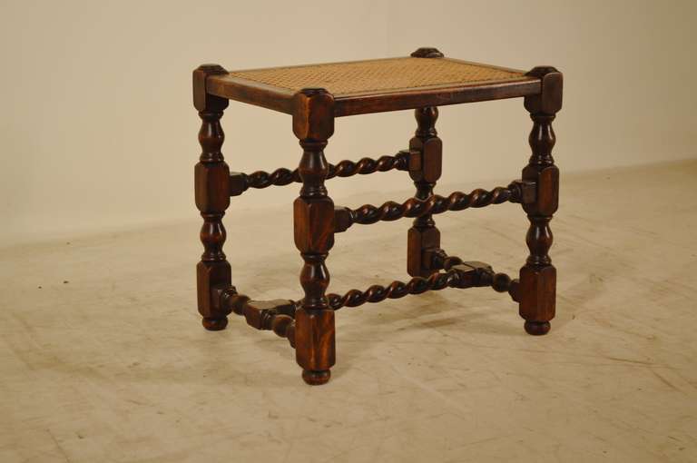 19th-C. English oak turned stool with barley twist stretchers and original cane top.