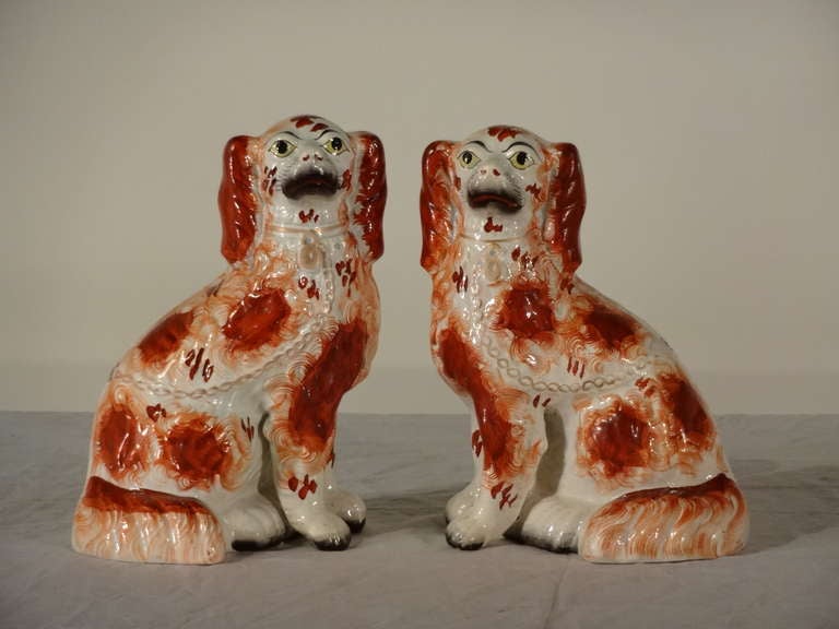 Wonderful pair of red Staffordshire dogs with separated front leg.  