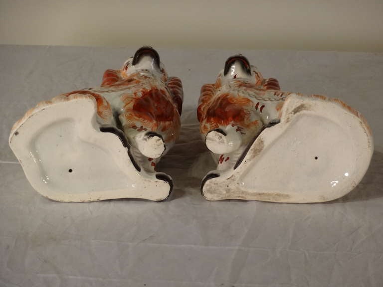 English 19th-C. Pair of Staffordshire Dogs with Separated Front Leg