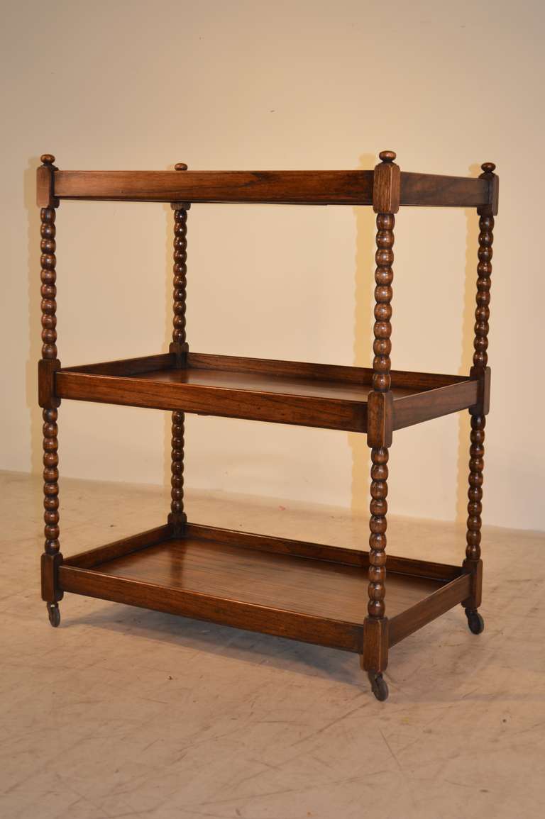 19th-C. English oak large bar cart with three shelf style and spool turned shelf supports.  Wonderfully connected by block connectors and raised on original casters.