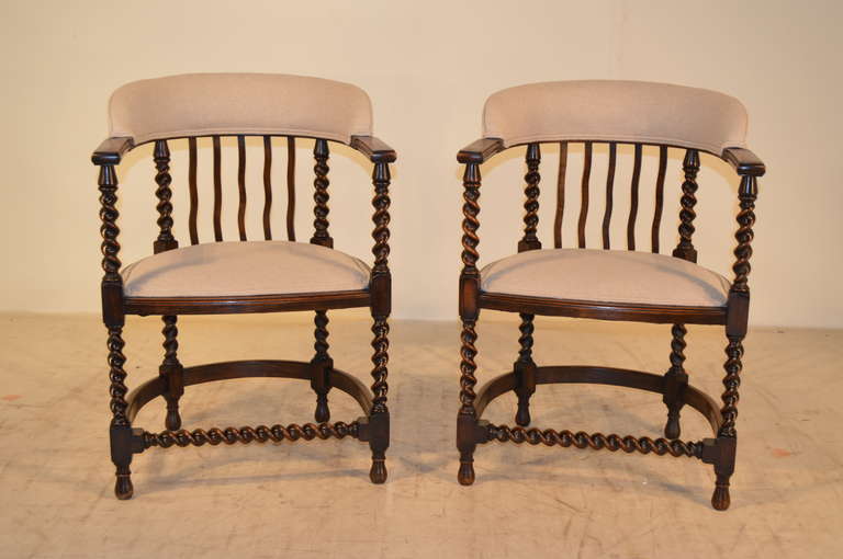 19th-C. Pair of unusual English oak arm chairs with barley twist legs and arm supports.  The chairs have been newly upholstered in linen and decorated with  double welt decoration.  The seat height is 18