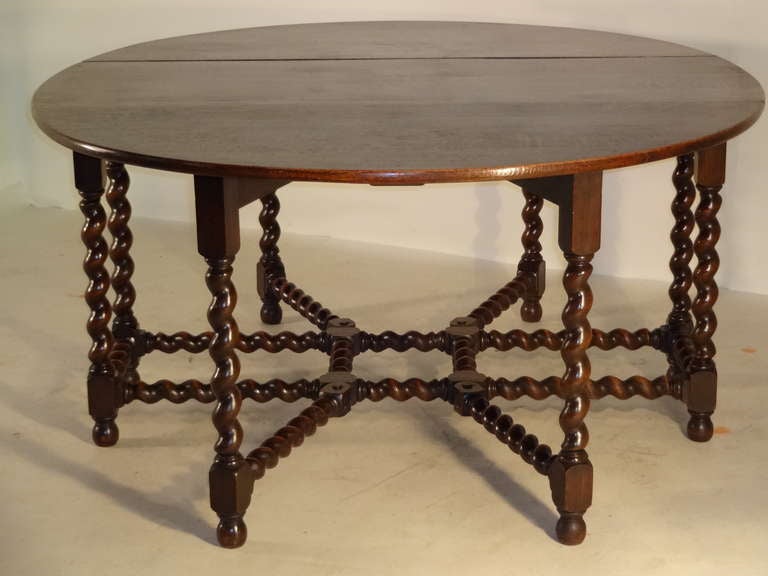 Late 19th century unusual English oak gate leg dining table with hand-turned barley twist legs and stretchers. The measurements are 23.25 when closed.