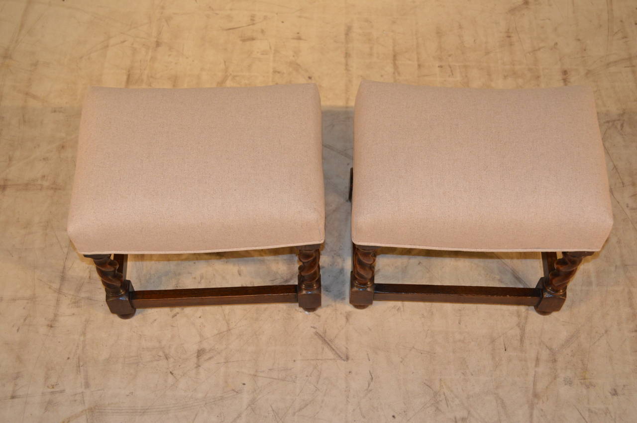 Late 19th Century pair of stools which have been newly upholstered in linen.  The legs are hand turned barley twist and are joined by stretchers.