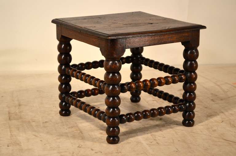 19th century English oak side table with a beveled edge around the top and wonderfully turned bobbin legs and stretchers.
